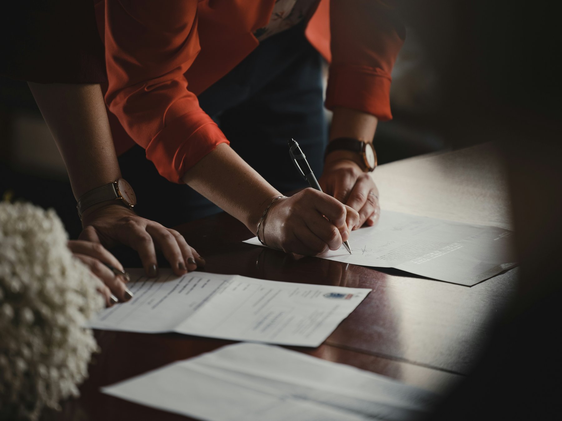 An agent signing partnership documents